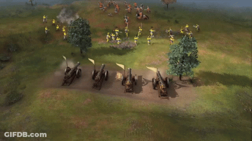 A Row Of Cannons Are Lined Up In A Field And Shooting GIF