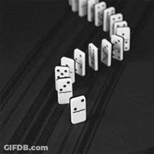 A Row Of Dominoes Are Lined Up On A Black Surface GIF