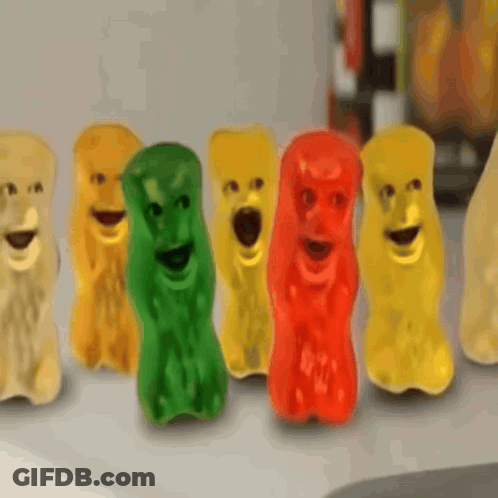 A Row Of Gummy Bears With Faces On Their Faces GIF