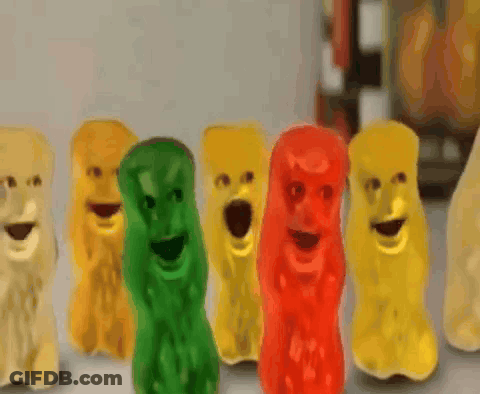A Row Of Gummy Bears With Their Mouths Wide Open GIF