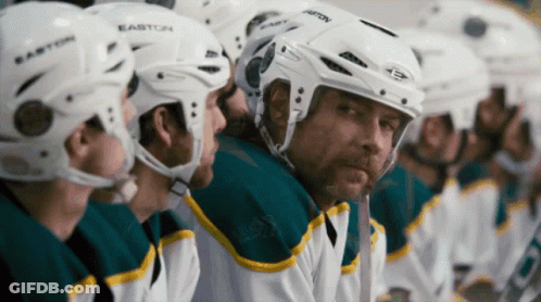 A Row Of Hockey Players Wearing Easton Helmets Sit On The Bench GIF