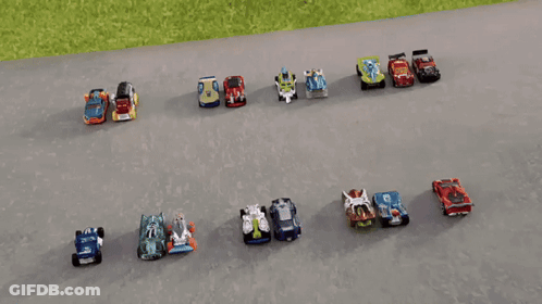 A Row Of Hot Wheels Cars Are Lined Up On The Road GIF