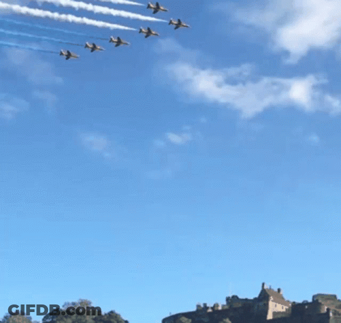 A Row Of Jets Flying In Formation With Red White And Blue Smoke Trails GIF