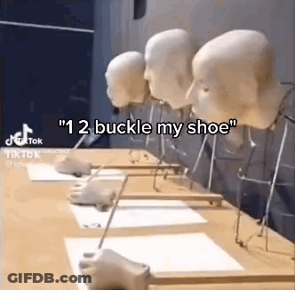 A Row Of Mannequin Heads Are Sitting On Top Of A Table . GIF