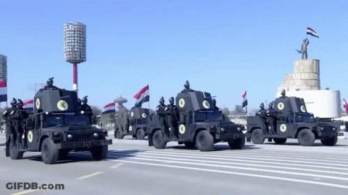 A Row Of Military Vehicles With The Number 13 On The Back GIF