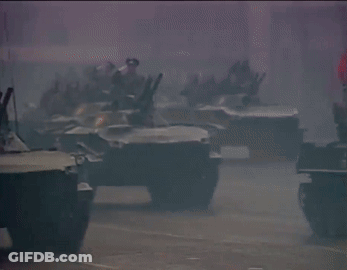 A Row Of Military Vehicles With The Number 7 On The Side Of One GIF