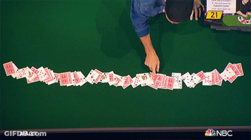 A Row Of Playing Cards On A Table With The Number 21 On The Table GIF