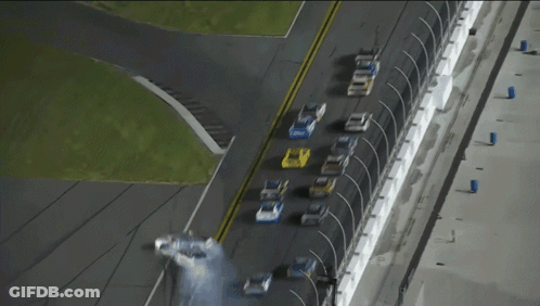 A Row Of Race Cars Are Lined Up On A Race Track And One Of Them Has The Word Ford On The Side GIF
