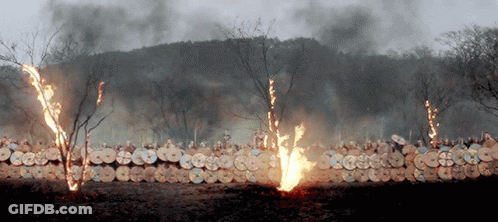 A Row Of Shields Are On Fire With Smoke Coming Out Of Them GIF