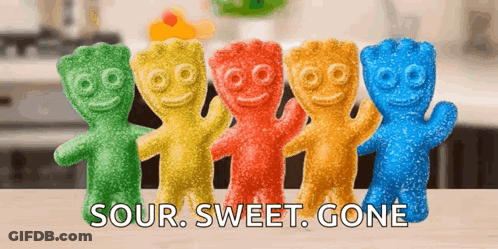 A Row Of Sour Sweet Gone Gummy Bears Are Lined Up On A Table GIF