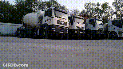 A Row Of Trucks Are Parked In A Parking Lot Including One That Says Man GIF