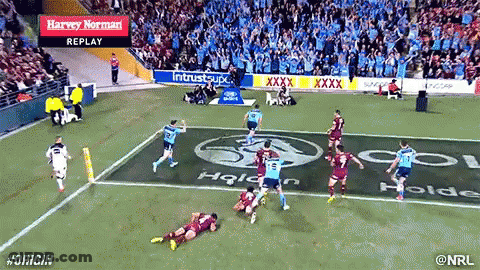 A Rugby Game Is Being Played In A Stadium With Advertisements For Harvey Norman In The Stands GIF