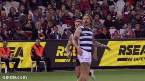 A Rugby Game Is Being Played In Front Of An Rsea Sign GIF