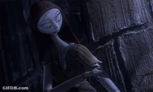 A Sally Doll From The Nightmare Before Christmas Talks On A Cell Phone GIF