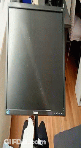 A Samsung Computer Monitor Is Sitting On A Table GIF