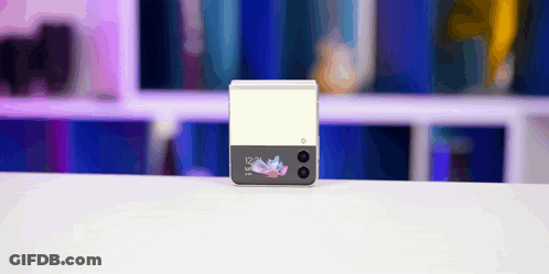 A Samsung Phone Is Sitting On A White Table With A Blurry Background GIF