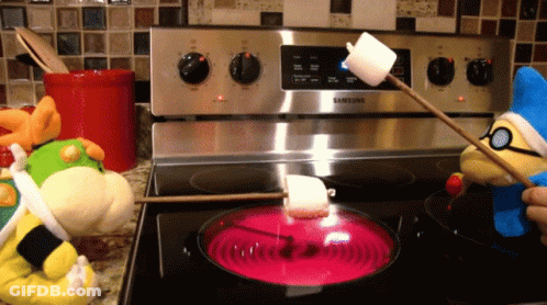 A Samsung Stove With Stuffed Animals Cooking Marshmallows On It GIF