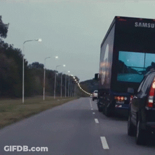 A Samsung Truck Is Driving Down The Highway GIF
