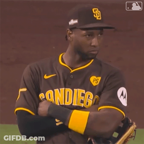 A San Diego Baseball Player With His Arms Crossed On The Field GIF