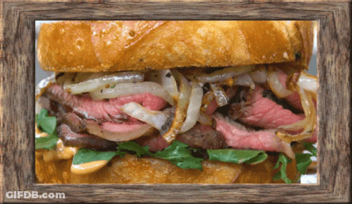 A Sandwich In A Wooden Frame With A Lot Of Meat And Onions GIF