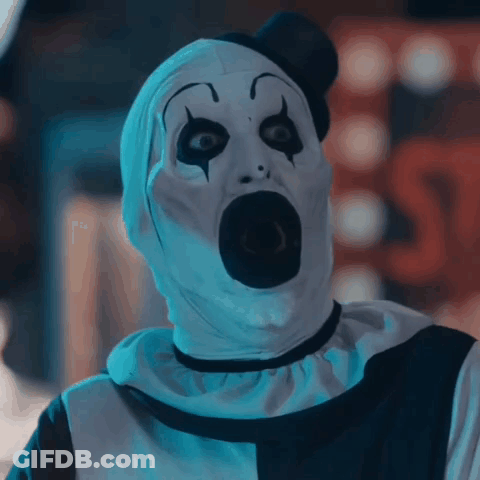 A Scary Clown With A Shocked Look On His Face GIF