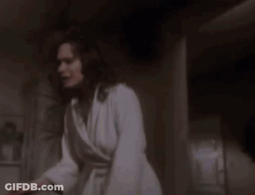 A Scary Doll Is Brushing Her Teeth In A Bathtub . GIF