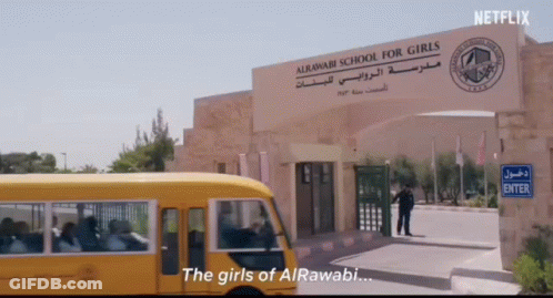 A School Bus Is Parked In Front Of A Sign That Says " The Girls Of Alrawabi " GIF