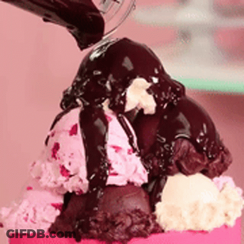 A Scoop Of Ice Cream With Chocolate Sauce On Top GIF