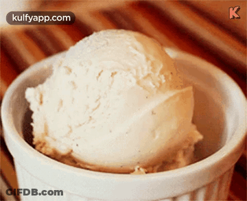 A Scoop Of Vanilla Ice Cream In A White Bowl With Kulfyapp.com In The Corner GIF