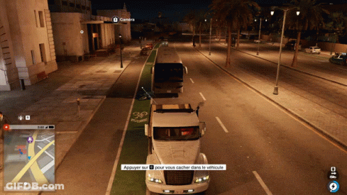 A Screenshot Of A Video Game Shows A Bus And A Truck Driving Down A Street At Night GIF