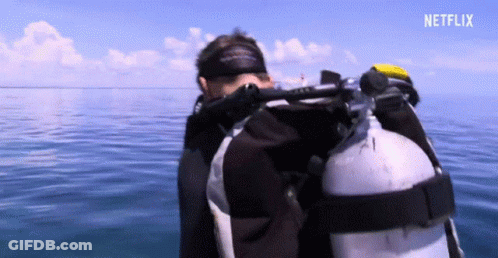 A Scuba Diver In The Ocean With A Netflix Logo In The Upper Right Corner GIF