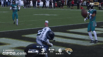 A Seahawks Football Player Is On The Field With A Fox Nfl Logo In The Background GIF