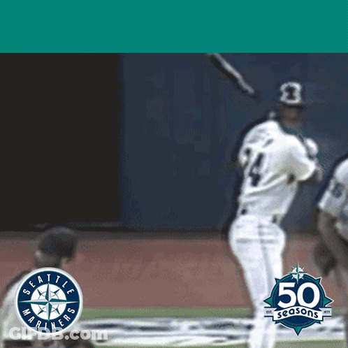 A Seattle Mariners Baseball Player Swings At A Ball GIF