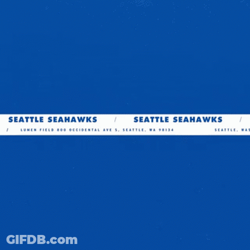 A Seattle Seahawks Logo With A Man Holding A Football GIF
