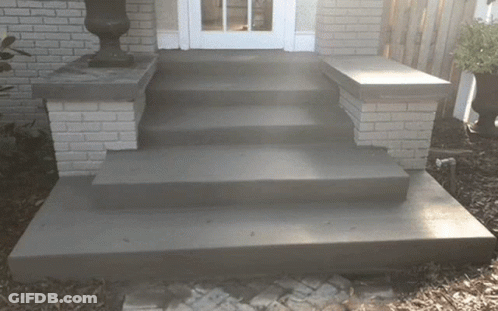 A Set Of Concrete Steps Leading Up To A House GIF