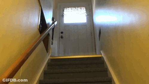 A Set Of Stairs Leading Up To A Door With A Curtains On It GIF