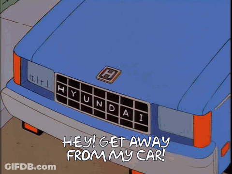 A Shadow Of A Man Is Cast On A Blue Hyundai GIF