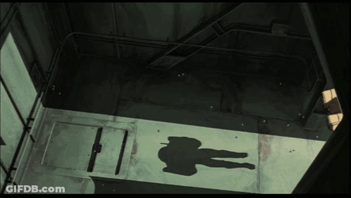 A Shadow Of A Person Is Cast On A Wall GIF