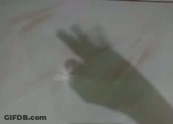 A Shadow Of A Person 'S Hand Pointing At Something GIF