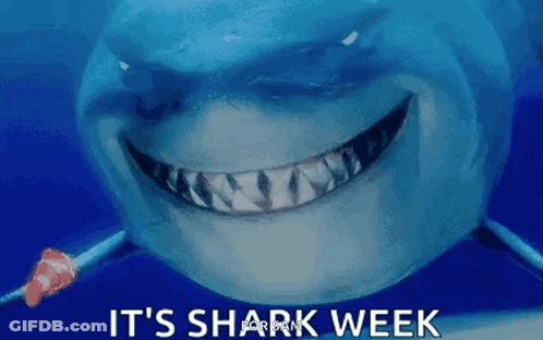 A Shark Is Smiling With The Words `` It 'S Shark Week '' Above It . GIF