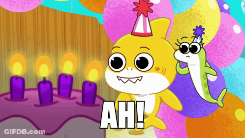 A Shark Wearing A Party Hat Stands Next To A Cake With Candles GIF