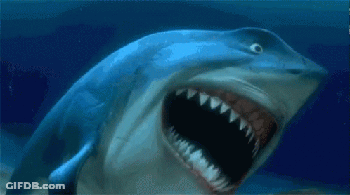 A Shark With Its Mouth Wide Open In The Ocean GIF