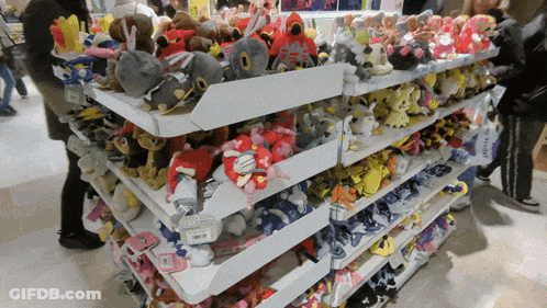 A Shelf Full Of Stuffed Animals With A Price Tag That Says ' Samsung ' On It GIF