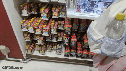 A Shelf Full Of Toys With One That Says ' Pokemon ' GIF