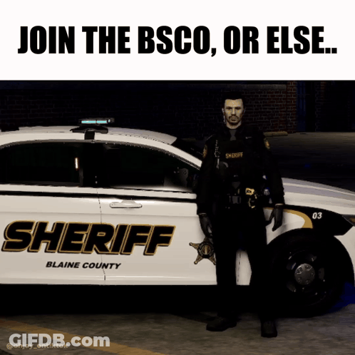 A Sheriff Stands In Front Of A Blaine County Sheriff Car GIF