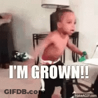 A Shirtless Baby Is Standing In A Room With The Words `` I 'M Grown ! '' GIF