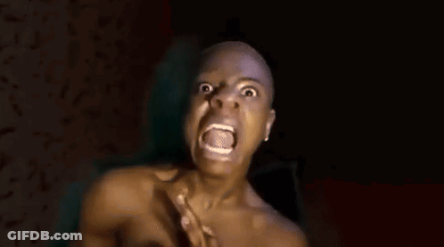 A Shirtless Bald Man Is Covering His Nose With His Hand . GIF