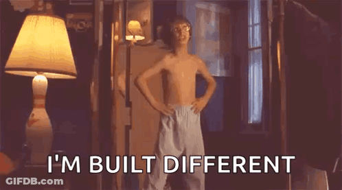 A Shirtless Boy Is Standing In A Room With His Hands On His Hips And Says `` I M Built Different '' . GIF