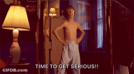 A Shirtless Boy Is Standing In A Room With His Hands On His Hips And Says `` Time To Get Serious ! '' GIF