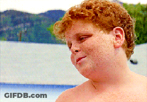A Shirtless Boy With Red Hair And Freckles Looks To The Side GIF